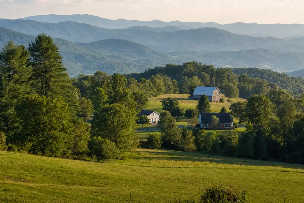 Rolling East Tennessee farmland with mature trees and blue Appalachian ridges near Johnson City